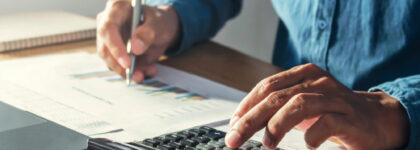 Businessman,working,on,desk,office,with,using,a,calculator,to