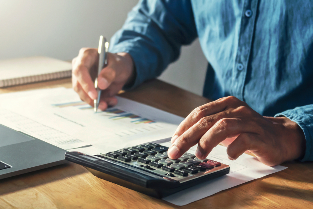 Businessman,working,on,desk,office,with,using,a,calculator,to